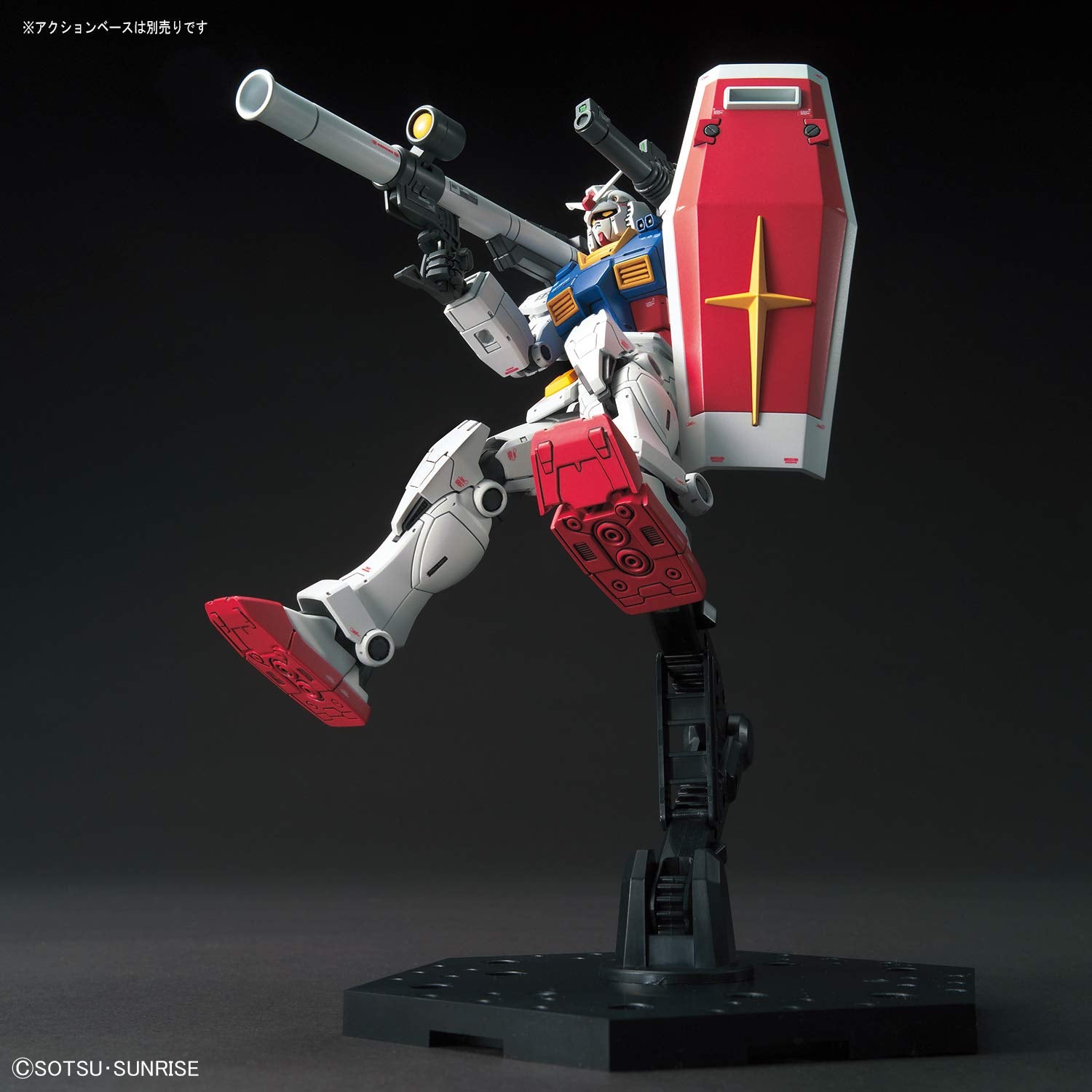 Model kit of a robot with red and white design on a black background