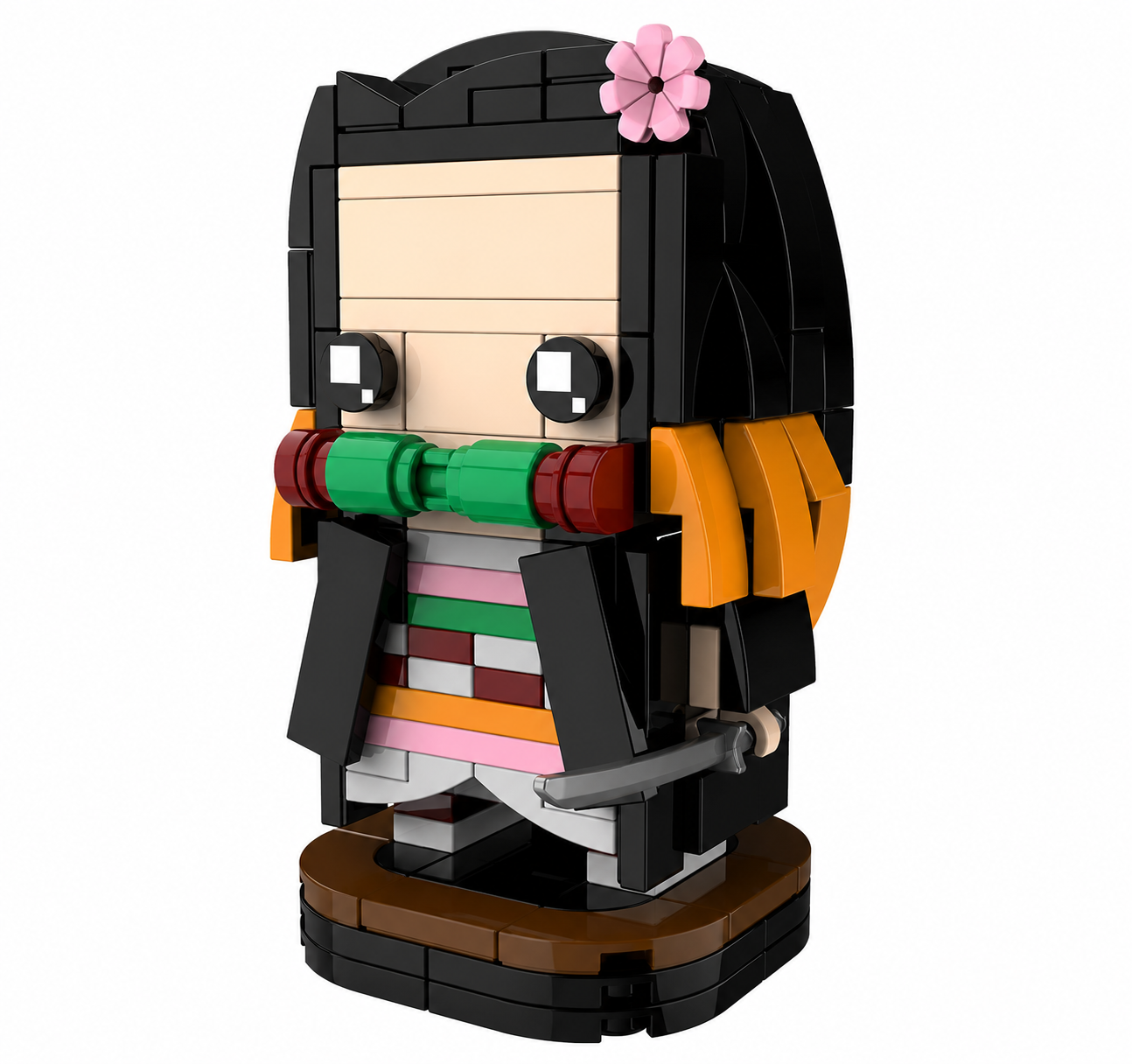 A block-built anime-style character figure on a round base, with black hair, a pink flower, orange side accents, a green and red mouth area, and a multicolored striped outfit, shown on a plain white background.