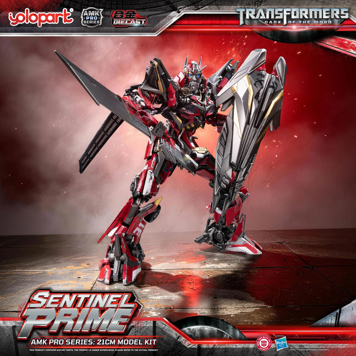 Action-posed photo of the YOLOPARK Sentinel Prime assembly model kit, gripping its signature double-bladed Primax Blade in one hand while raising its large rectangular, cybernetic shield defensively. The complex inner die-cast skeletal framing and joint linkages are exposed at the elbows and knees, highlighting the figure's highly articulated construction.